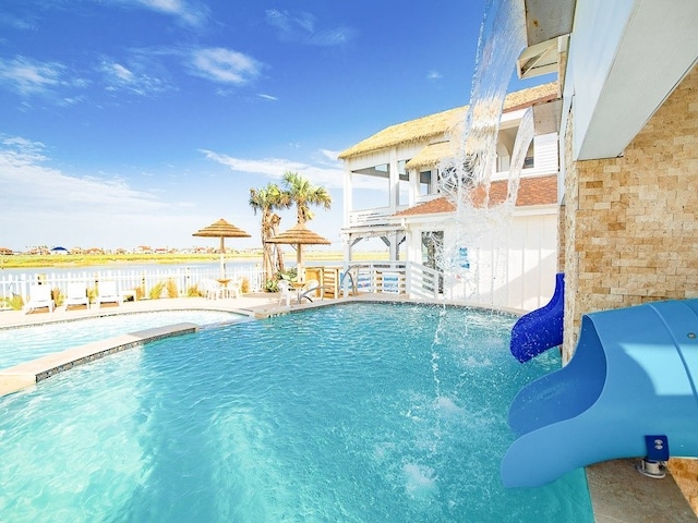 view of pool with a patio area and pool water feature