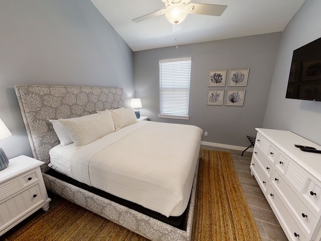 bedroom featuring lofted ceiling, ceiling fan, and dark hardwood / wood-style floors