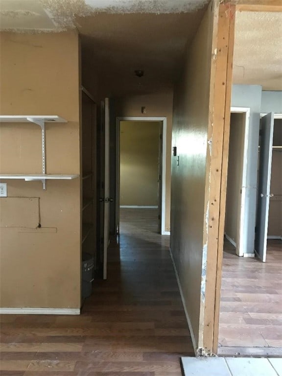 corridor with wood-type flooring