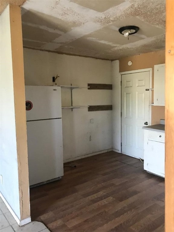 kitchen featuring white cabinets, dark hardwood / wood-style floors, and white refrigerator