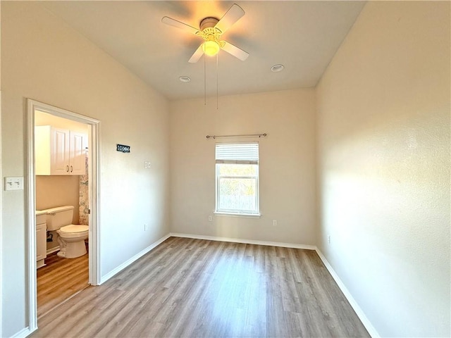 141 Barnacle Dr, Rockport, TX 78382 - unfurnished bedroom with ceiling fan, light wood-style flooring, baseboards, and connected bathroom