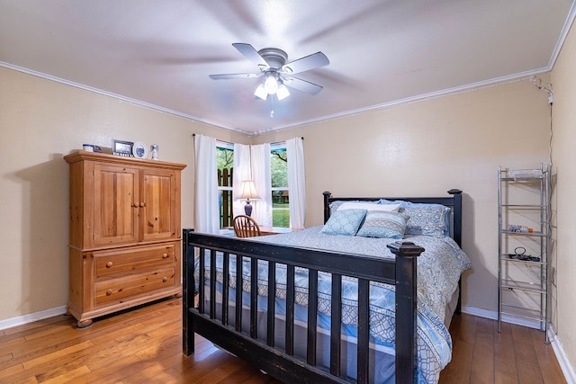 bedroom featuring hardwood / wood-style floors, ceiling fan, and crown molding