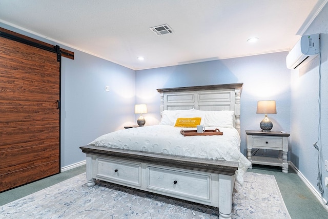 bedroom featuring an AC wall unit, a barn door, dark carpet, and crown molding