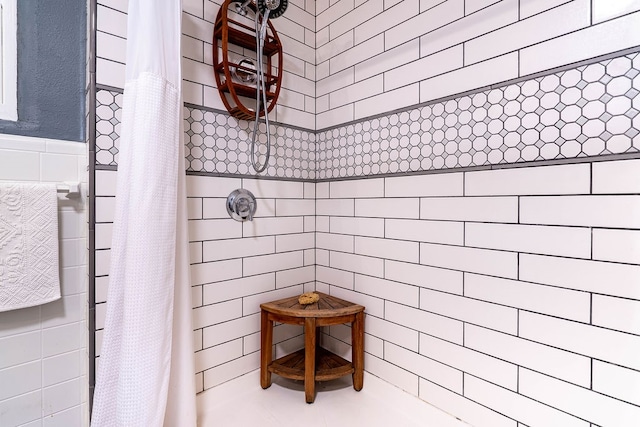 bathroom featuring tile walls and a shower with curtain