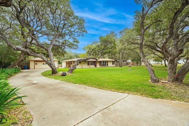 single story home featuring a garage and a front lawn