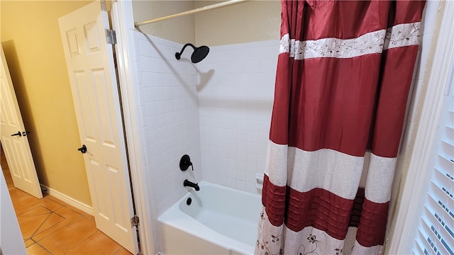 bathroom with shower / bath combo with shower curtain and tile patterned floors