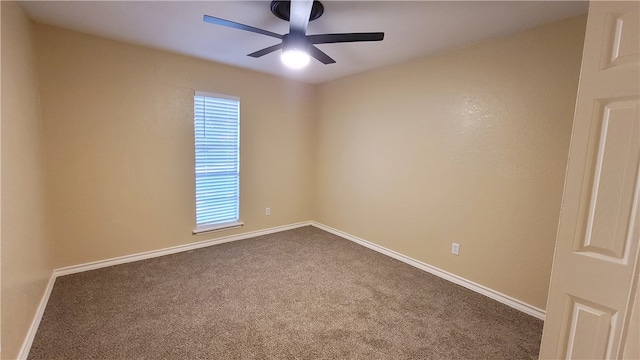 carpeted spare room with ceiling fan