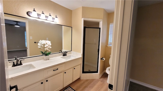 bathroom with toilet, an enclosed shower, vanity, and wood-type flooring