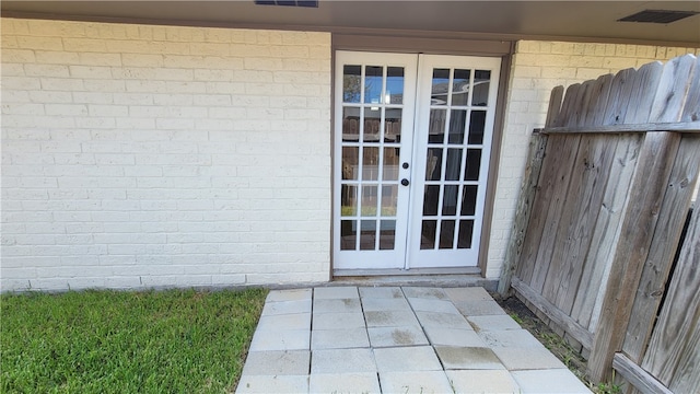 property entrance featuring french doors and a patio area