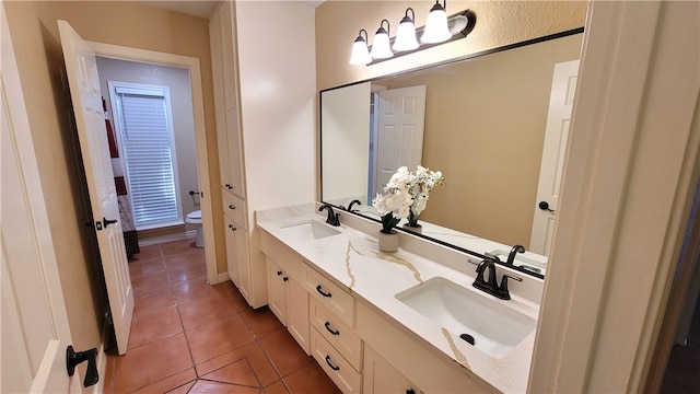 bathroom featuring toilet, vanity, and tile patterned floors