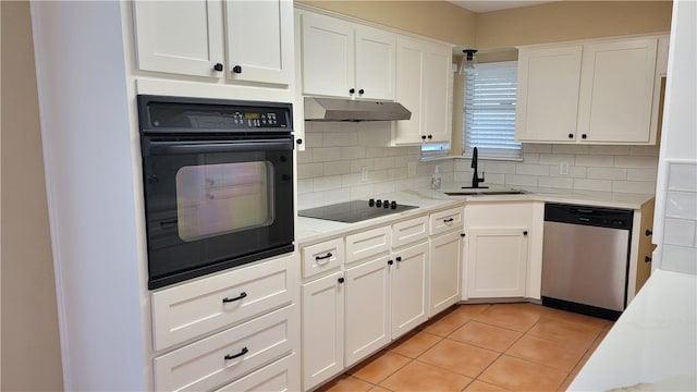 kitchen with light tile patterned floors, white cabinetry, sink, and black appliances