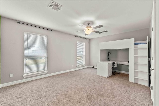 unfurnished bedroom with light colored carpet and ceiling fan