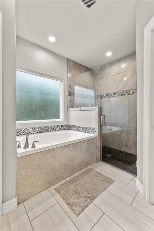 bathroom with plus walk in shower and tile patterned floors