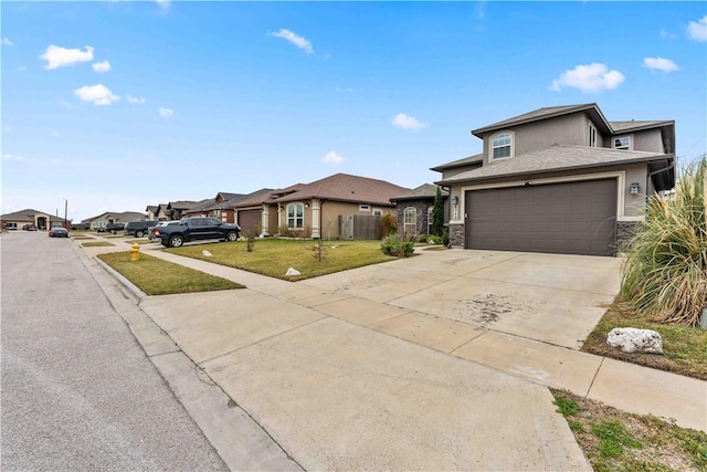 view of front of house featuring a garage and a front lawn