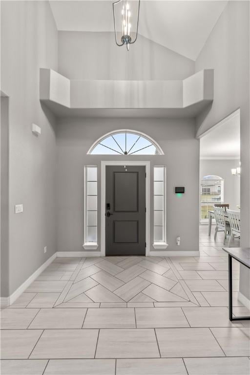 entryway featuring a notable chandelier and a high ceiling