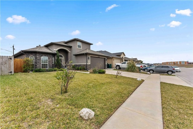 view of front of home featuring a garage and a front yard