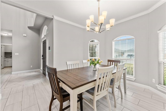 dining space with crown molding and an inviting chandelier