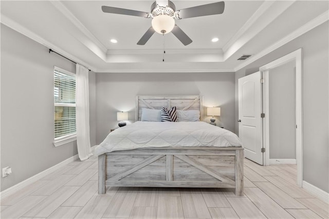 bedroom featuring ornamental molding, ceiling fan, and a raised ceiling