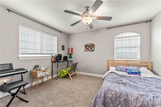 carpeted bedroom with ceiling fan and multiple windows