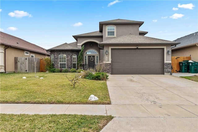 view of front of home with a garage and a front lawn