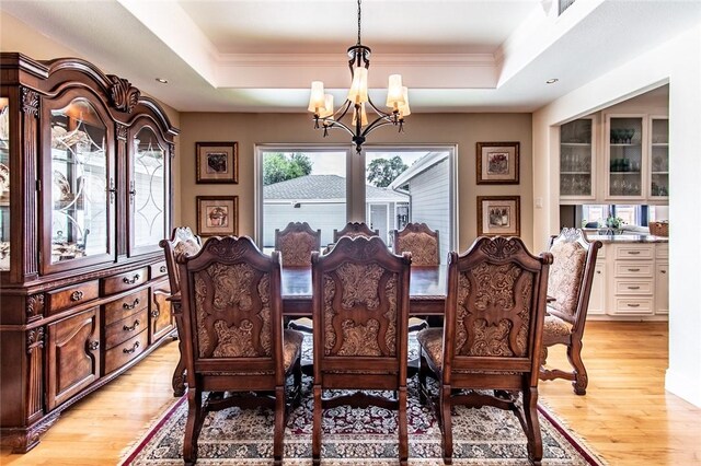 322 Williamson Pl, Corpus Christi, TX 78411 - dining area with a tray ceiling, a chandelier, light wood-style flooring, and ornamental molding