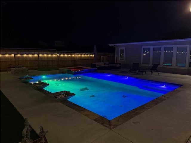 322 Williamson Pl, Corpus Christi, TX 78411 - pool at twilight with a patio, a pool with connected hot tub, and a fenced backyard