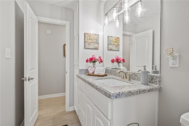 bathroom featuring hardwood / wood-style flooring and vanity