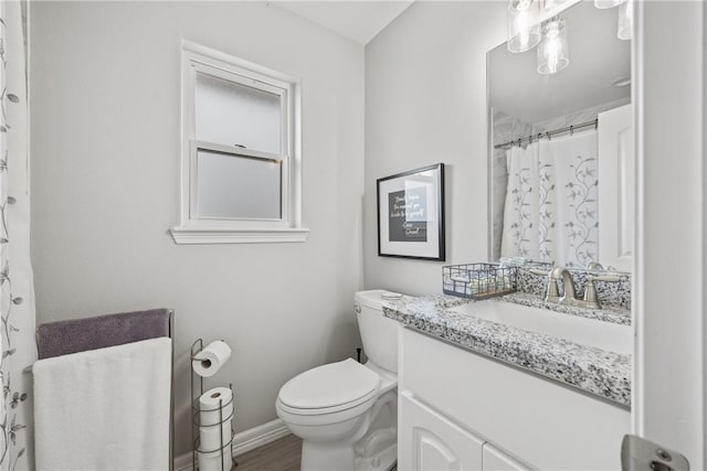 bathroom featuring hardwood / wood-style flooring, vanity, toilet, and a shower with curtain