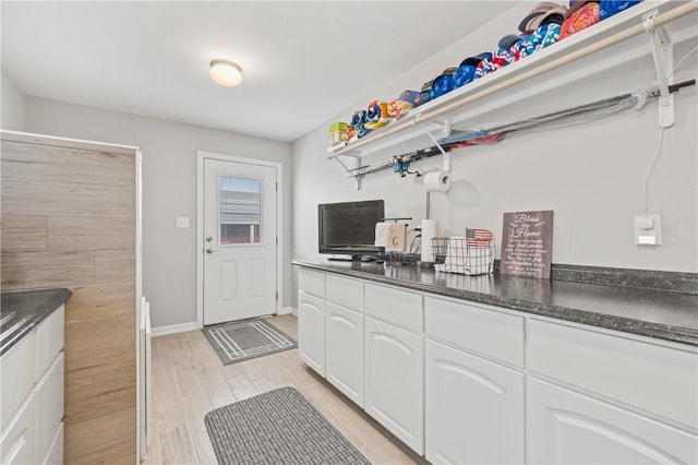 kitchen featuring white cabinets and light wood-type flooring