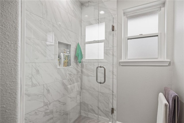 bathroom with a shower with door