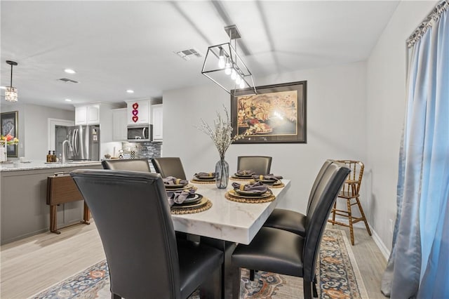 dining area with light hardwood / wood-style floors