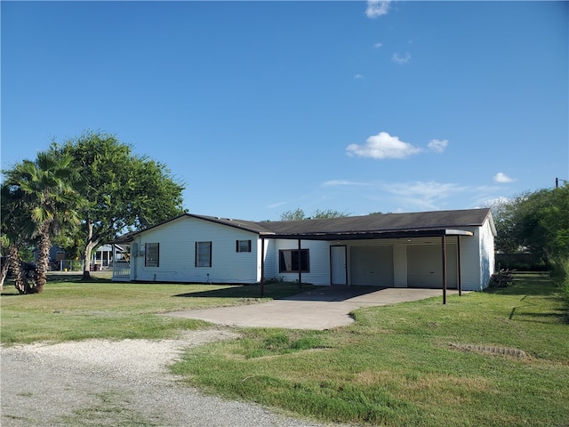 view of front facade featuring a front yard and a carport