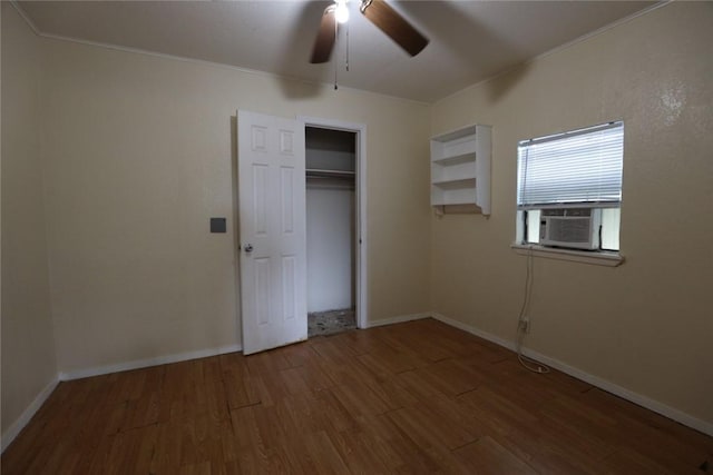 unfurnished bedroom featuring ceiling fan, a closet, cooling unit, and wood-type flooring