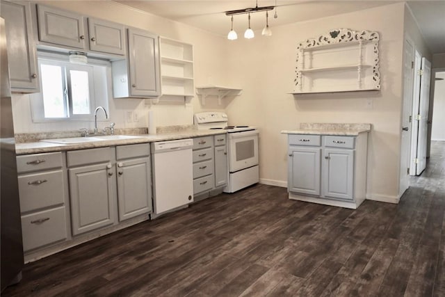 kitchen featuring gray cabinetry, white appliances, dark wood-type flooring, sink, and hanging light fixtures