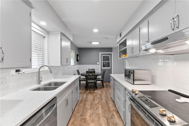 3818 Kingston Dr, Corpus Christi, TX 78415 - kitchen featuring appliances with stainless steel finishes, under cabinet range hood, tasteful backsplash, light countertops, and recessed lighting
