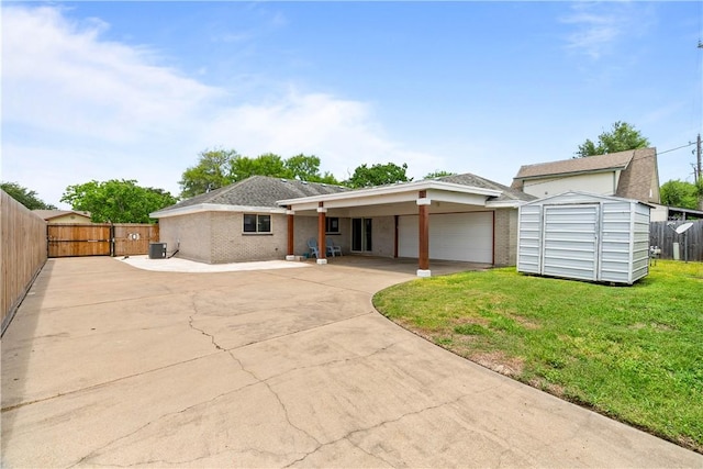 3818 Kingston Dr, Corpus Christi, TX 78415 - ranch-style house featuring a garage, concrete driveway, a storage unit, and brick siding
