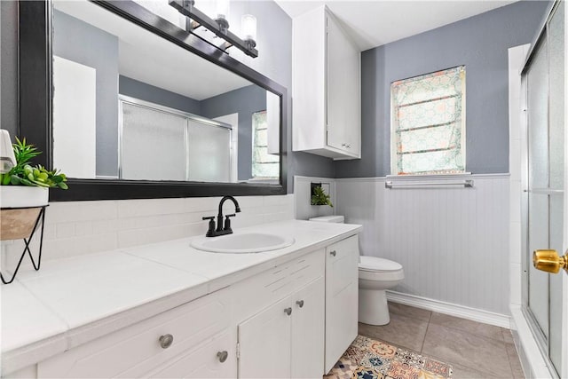 3818 Kingston Dr, Corpus Christi, TX 78415 - full bathroom with plenty of natural light, vanity, a shower with shower door, and a wainscoted wall