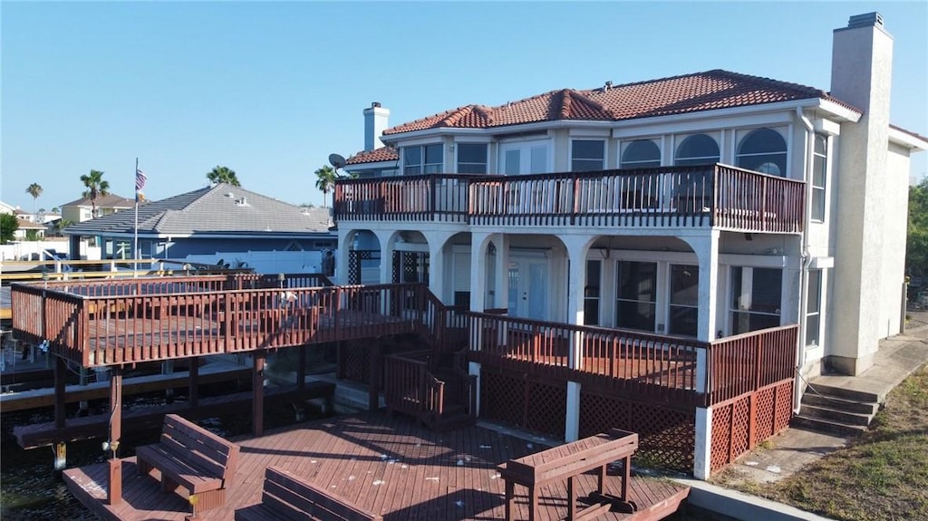 13558 Carlos Fifth Ct, Corpus Christi, TX 78418 - back of property with a chimney, stairs, and a deck