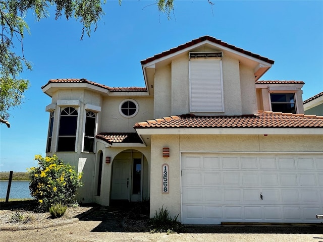 mediterranean / spanish-style house featuring a garage