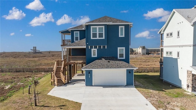 view of front of home with a garage, fence, stairs, stucco siding, and a front yard