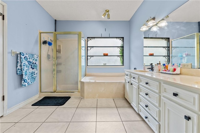 7401 Blue Lake Dr, Corpus Christi, TX 78413 - full bathroom with a bath, a shower stall, double vanity, and tile patterned flooring