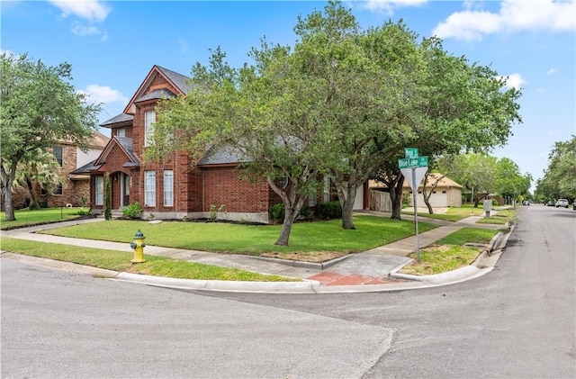 7401 Blue Lake Dr, Corpus Christi, TX 78413 - view of front facade with brick siding and a front lawn