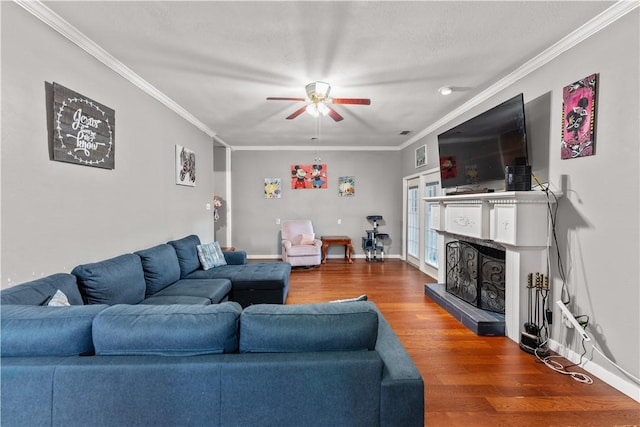 7401 Blue Lake Dr, Corpus Christi, TX 78413 - living room featuring wood finished floors, a ceiling fan, a fireplace with raised hearth, and ornamental molding