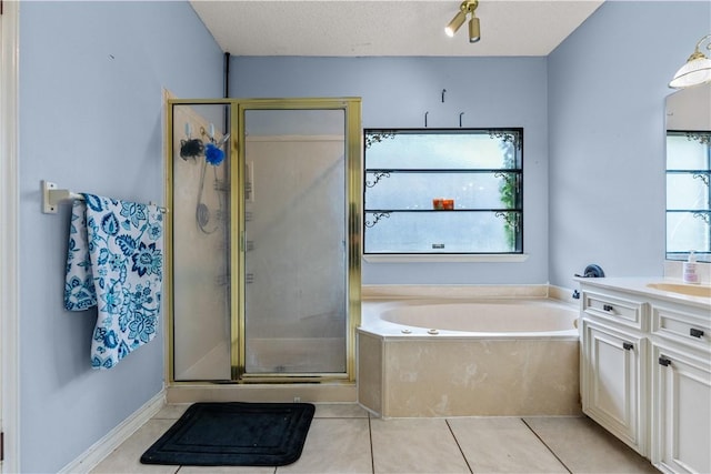 7401 Blue Lake Dr, Corpus Christi, TX 78413 - full bath featuring healthy amount of natural light, vanity, a garden tub, and tile patterned flooring