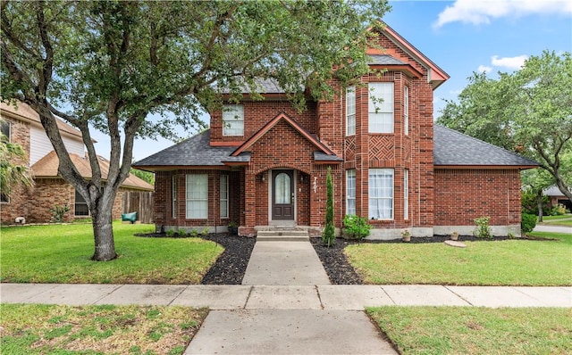 7401 Blue Lake Dr, Corpus Christi, TX 78413 - view of front of house featuring a shingled roof, brick siding, and a front yard