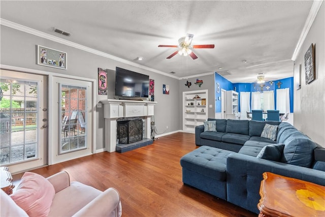 7401 Blue Lake Dr, Corpus Christi, TX 78413 - living area with ceiling fan, crown molding, wood finished floors, and a fireplace with raised hearth