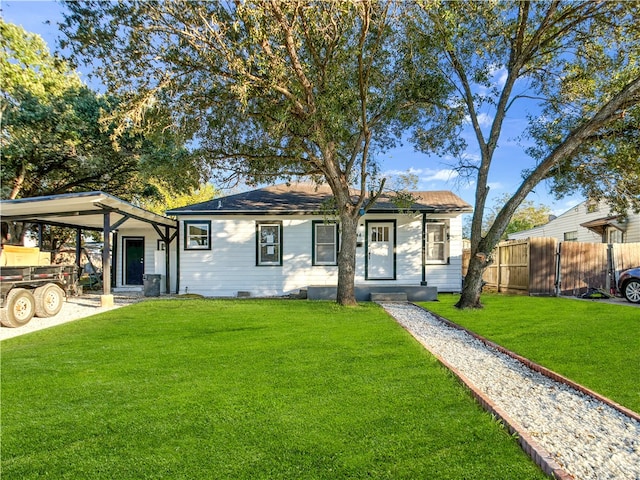 view of front facade featuring a front lawn and a carport