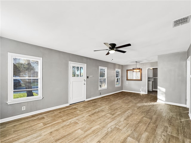 unfurnished living room with ceiling fan and light hardwood / wood-style flooring