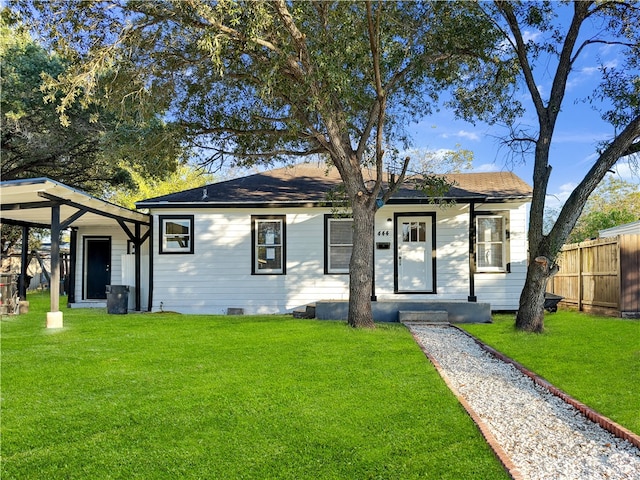 view of front of property with a front yard and a carport