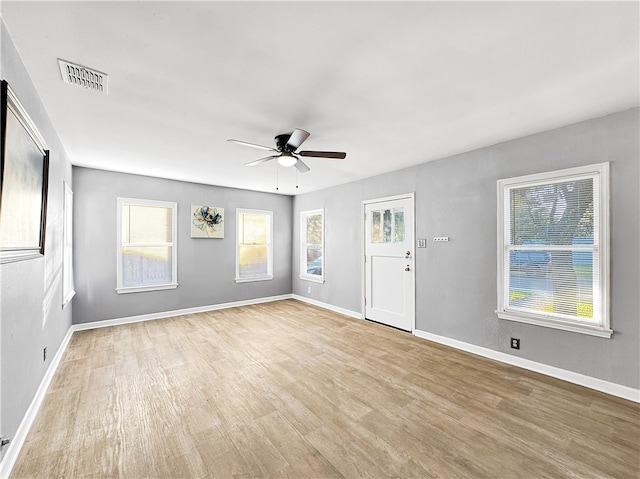 empty room featuring light hardwood / wood-style flooring and ceiling fan